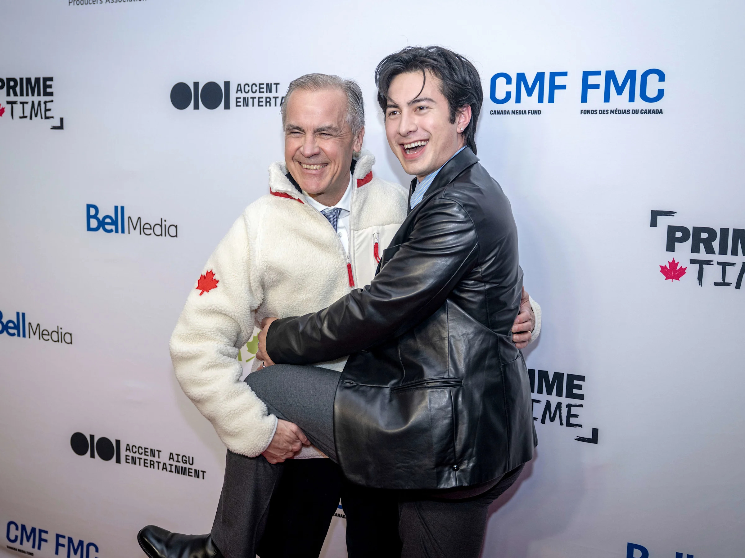 Mark Carney poses with Hudson Williams (Photo by Andrej Ivanov/Getty Images)